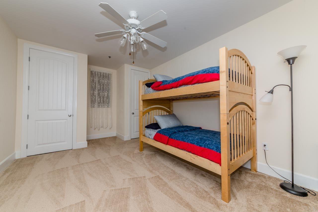 13928 River Road, Unit 504 Perdido Key, FL 32507 - Photo 25 of 40 a bedroom with bed and a chandelier