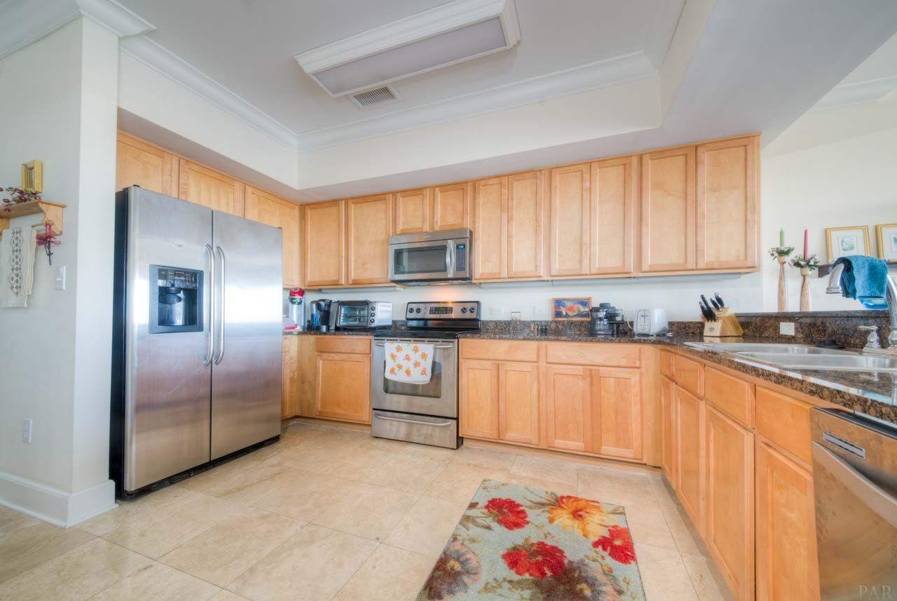 13928 River Road, Unit 504 Perdido Key, FL 32507 - Photo 3 of 40 a kitchen with granite countertop a refrigerator sink and microwave