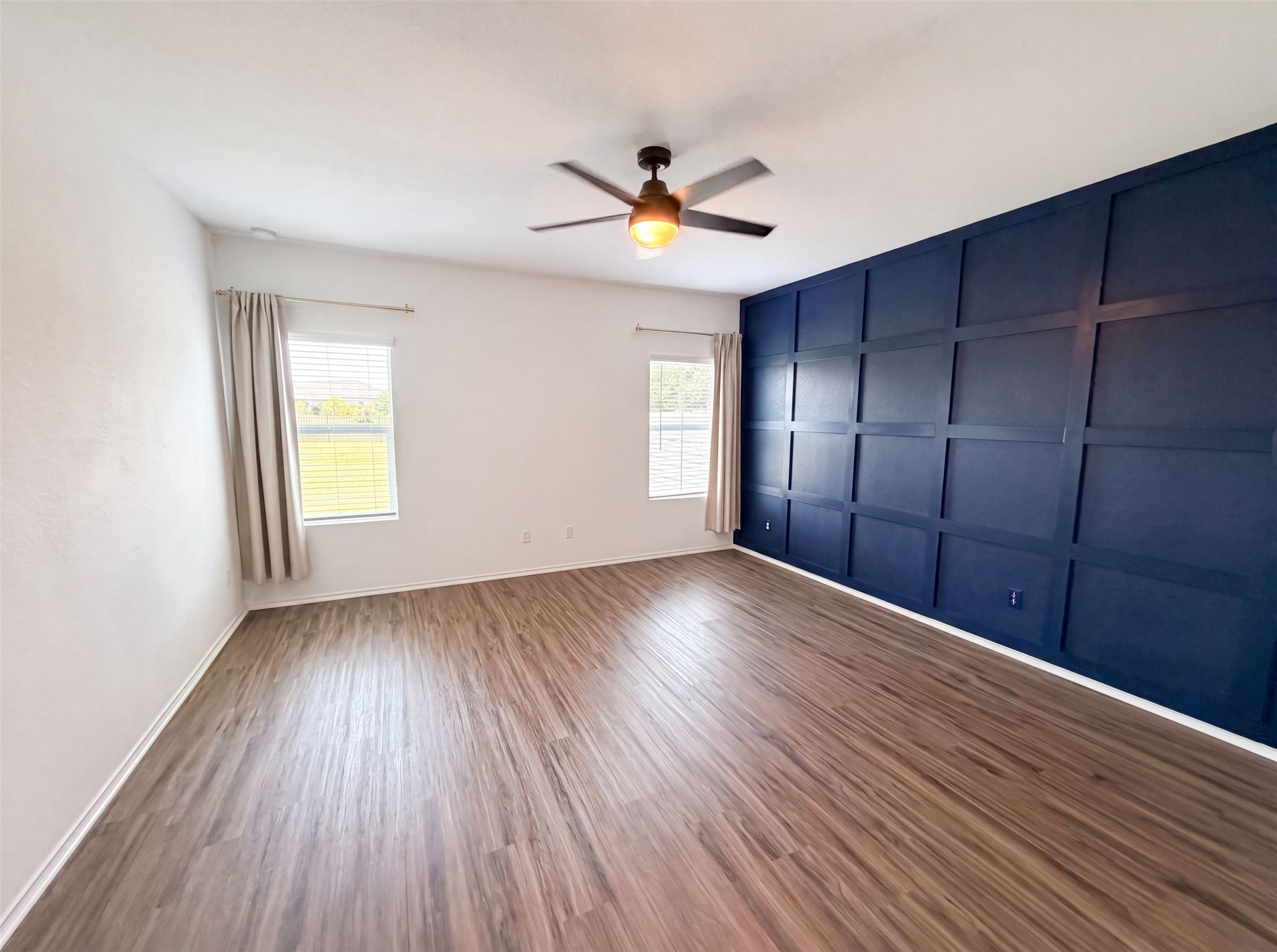 424 Wolf Springs Road Georgetown, TX 78628 - Photo 4 of 15 Laminate flooring throughout this airy space with a captivating navy accent wall.