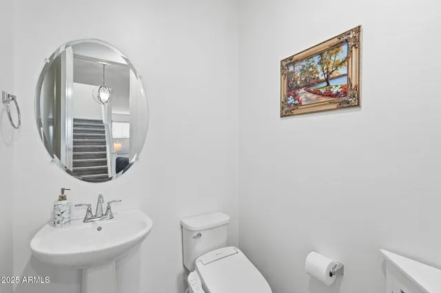 a view of a hallway with closet and a bathroom