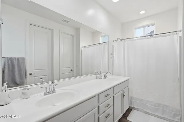 a view of walk in closet with clothes