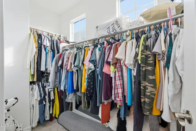 a bedroom with a bed and a ceiling fan