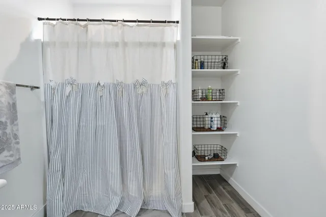 a view of a patio with table and chairs and potted plants