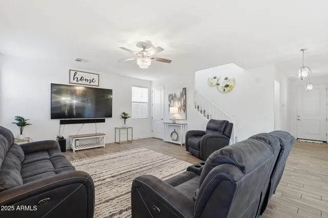 a kitchen with a center island white cabinets and stainless steel appliances