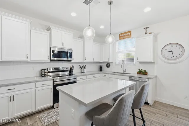 a view of a dining room with furniture wooden floor and chandelier