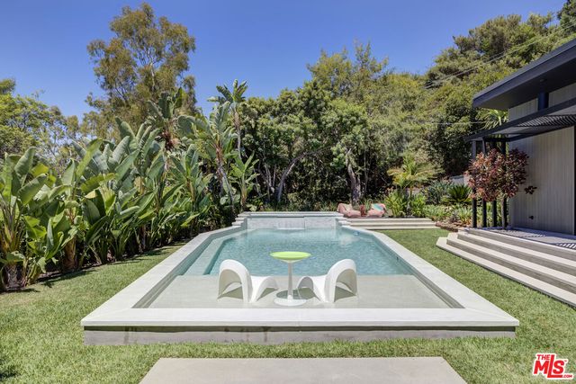 a view of swimming pool with outdoor seating