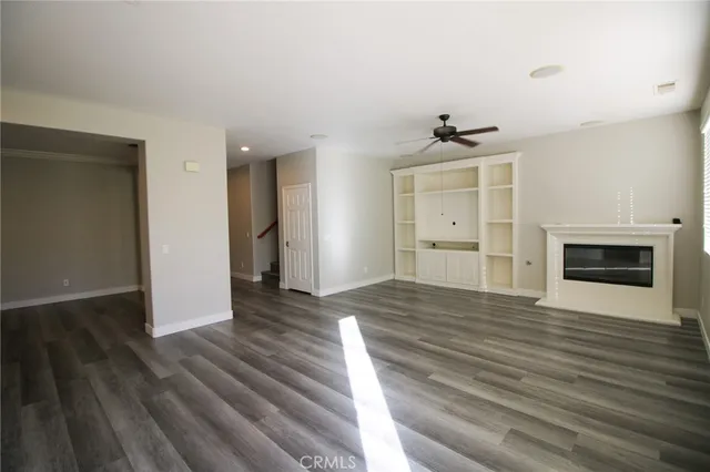 wooden floor in an empty room with a fireplace