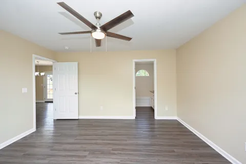 a view of an empty room and wooden floor