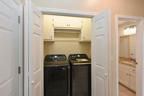 a close view of a utility room with dryer and washer