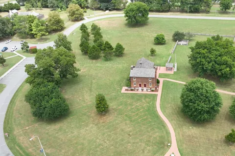 an aerial view of a house with a yard