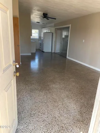an empty room with a fireplace and windows