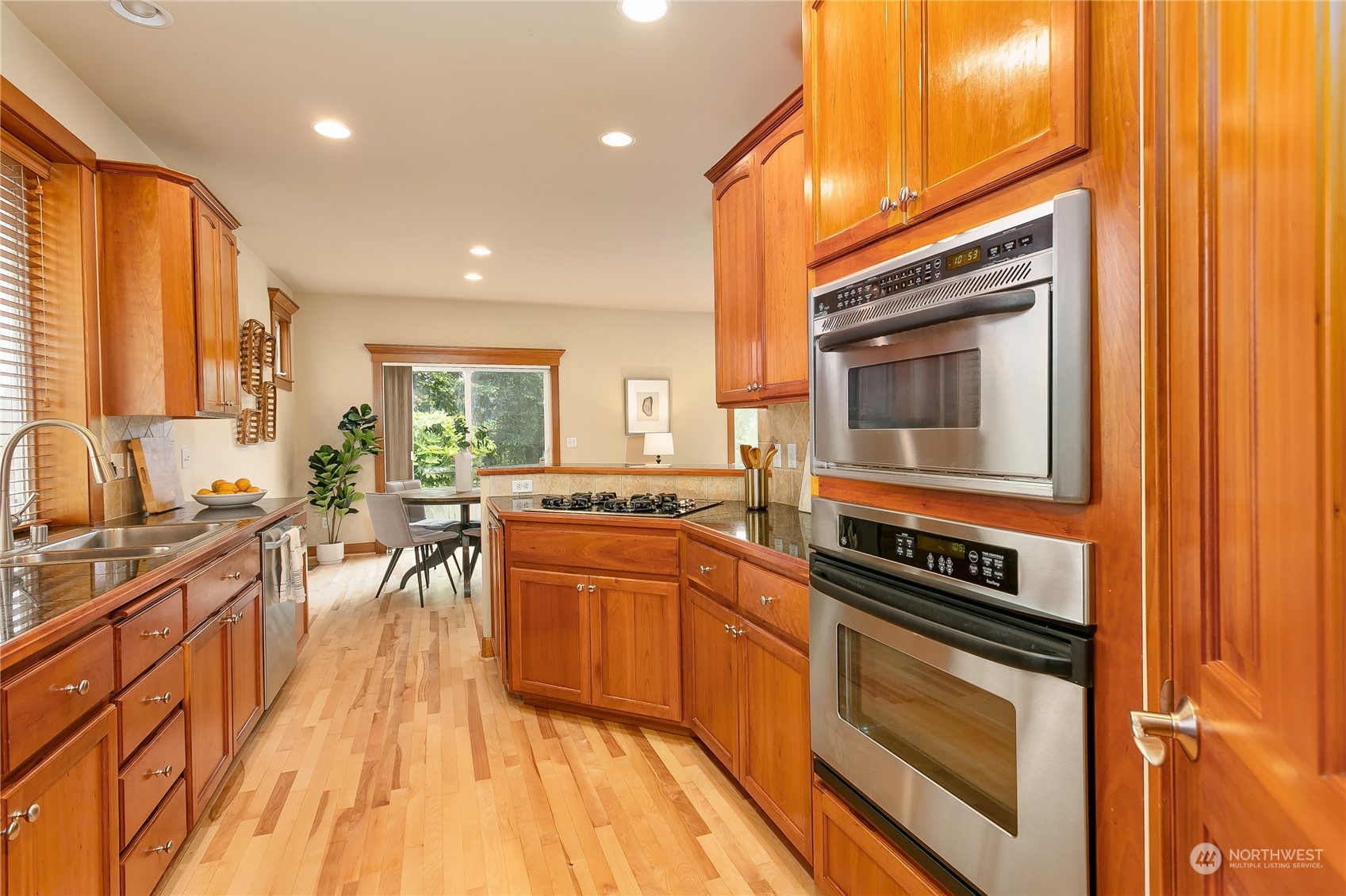 16725 Southeast 173rd Street Renton, WA 98058 - Photo 14 of 37 a kitchen with stainless steel appliances granite countertop a stove a sink and a microwave