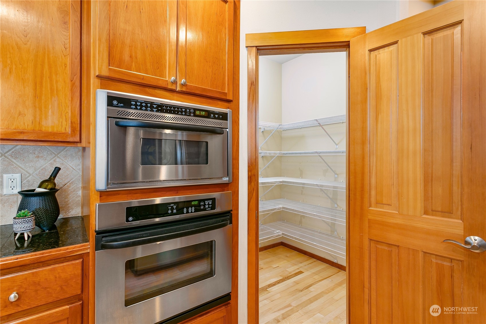16725 Southeast 173rd Street Renton, WA 98058 - Photo 17 of 37 a kitchen with a stove and a microwave