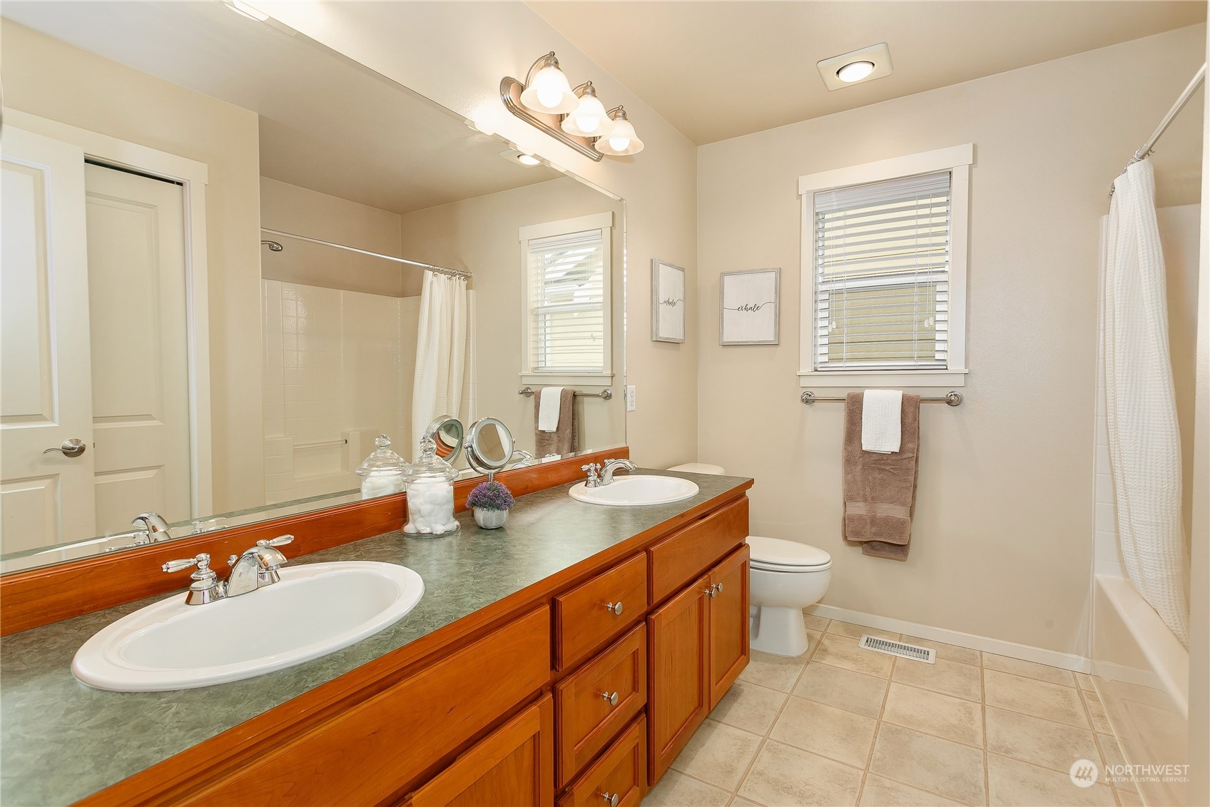 16725 Southeast 173rd Street Renton, WA 98058 - Photo 21 of 37 a bathroom with a double vanity sink a mirror and a