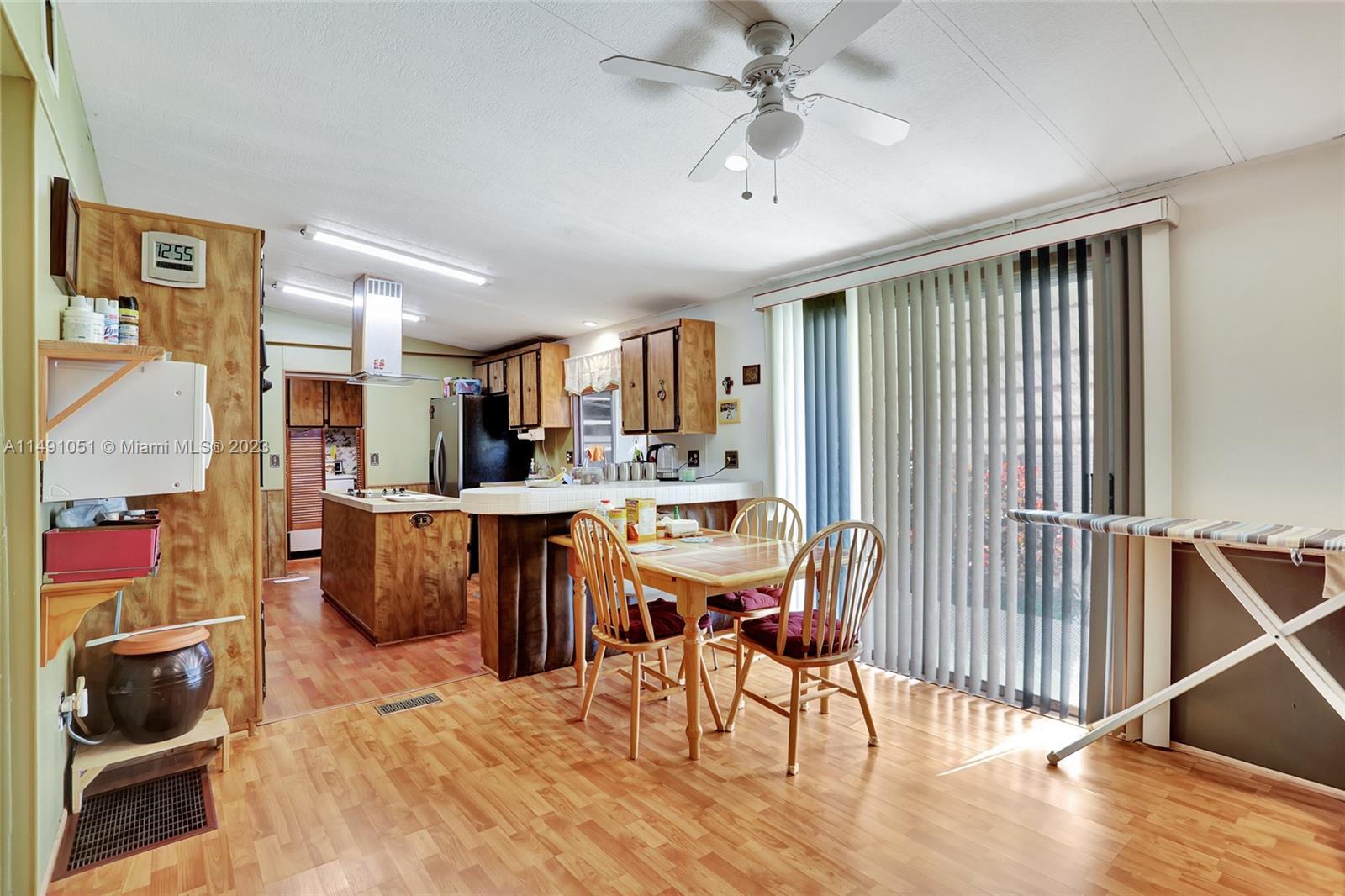 1640 Southwest 66th Avenue Boca Raton, FL 33428 - Photo 11 of 36 a living room with furniture a dining table and chairs with wooden floor