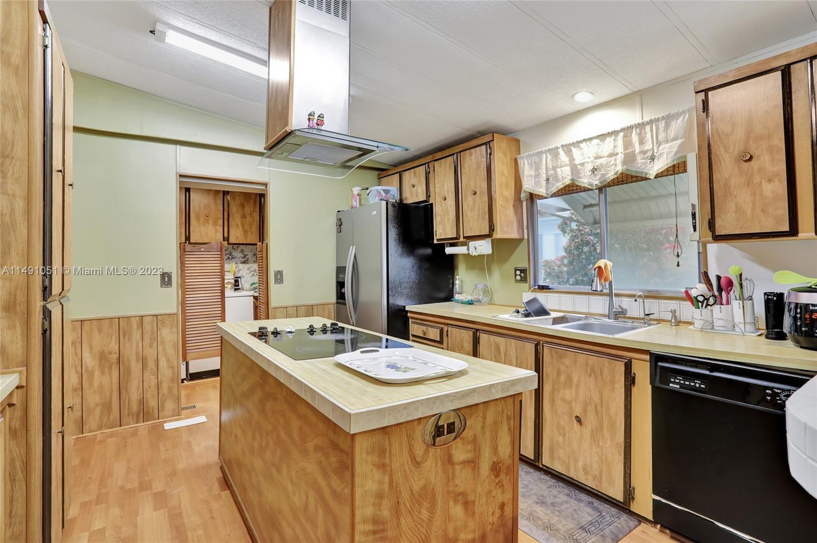 1640 Southwest 66th Avenue Boca Raton, FL 33428 - Photo 14 of 36 a kitchen with a sink stove and cabinets