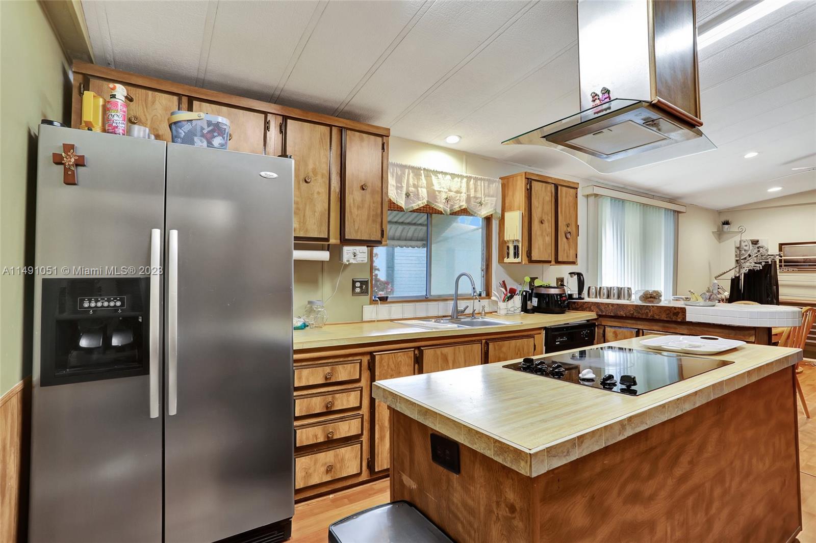 1640 Southwest 66th Avenue Boca Raton, FL 33428 - Photo 15 of 36 a kitchen with stainless steel appliances granite countertop a refrigerator a sink and a stove