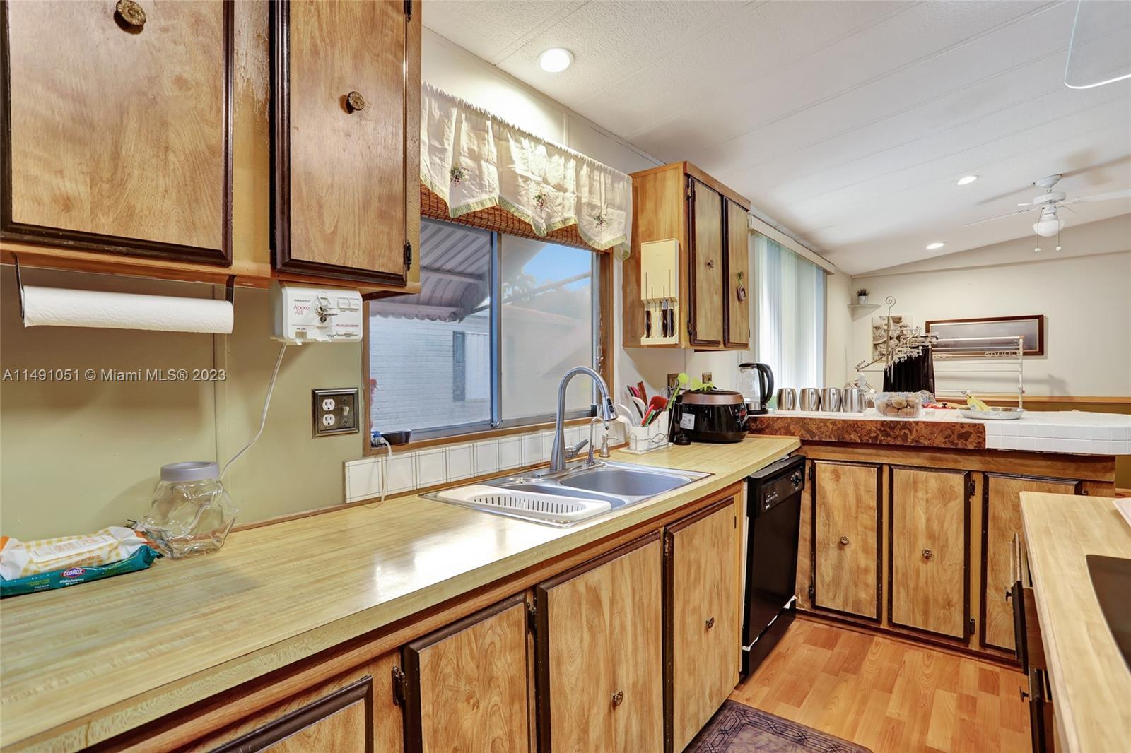 1640 Southwest 66th Avenue Boca Raton, FL 33428 - Photo 16 of 36 a kitchen with a sink appliances and cabinets