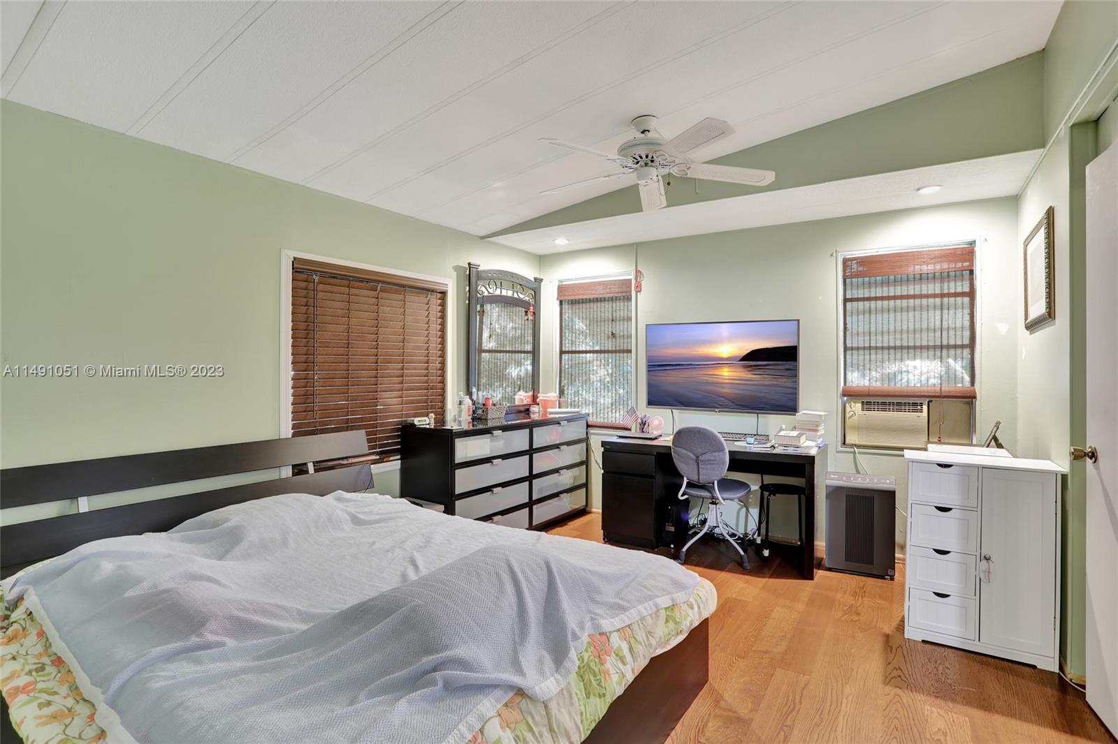 1640 Southwest 66th Avenue Boca Raton, FL 33428 - Photo 23 of 36 a bedroom with a bed and a desk