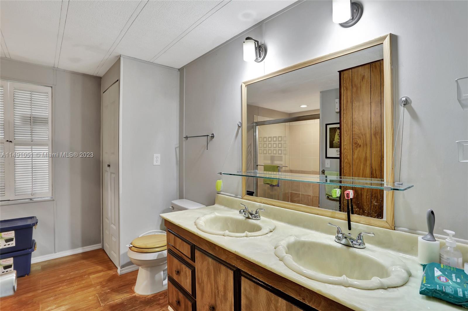 1640 Southwest 66th Avenue Boca Raton, FL 33428 - Photo 25 of 36 a bathroom with a granite countertop sink toilet and shower