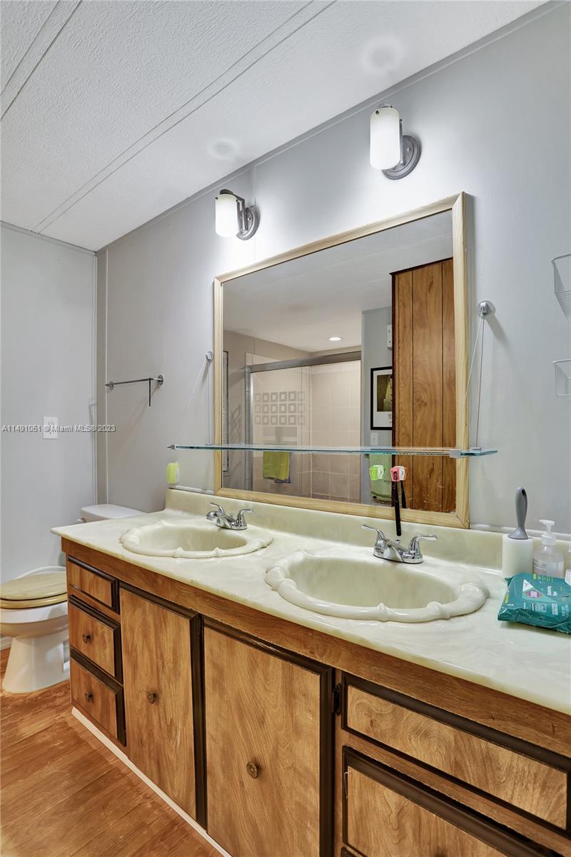1640 Southwest 66th Avenue Boca Raton, FL 33428 - Photo 26 of 36 a bathroom with a sink and a mirror
