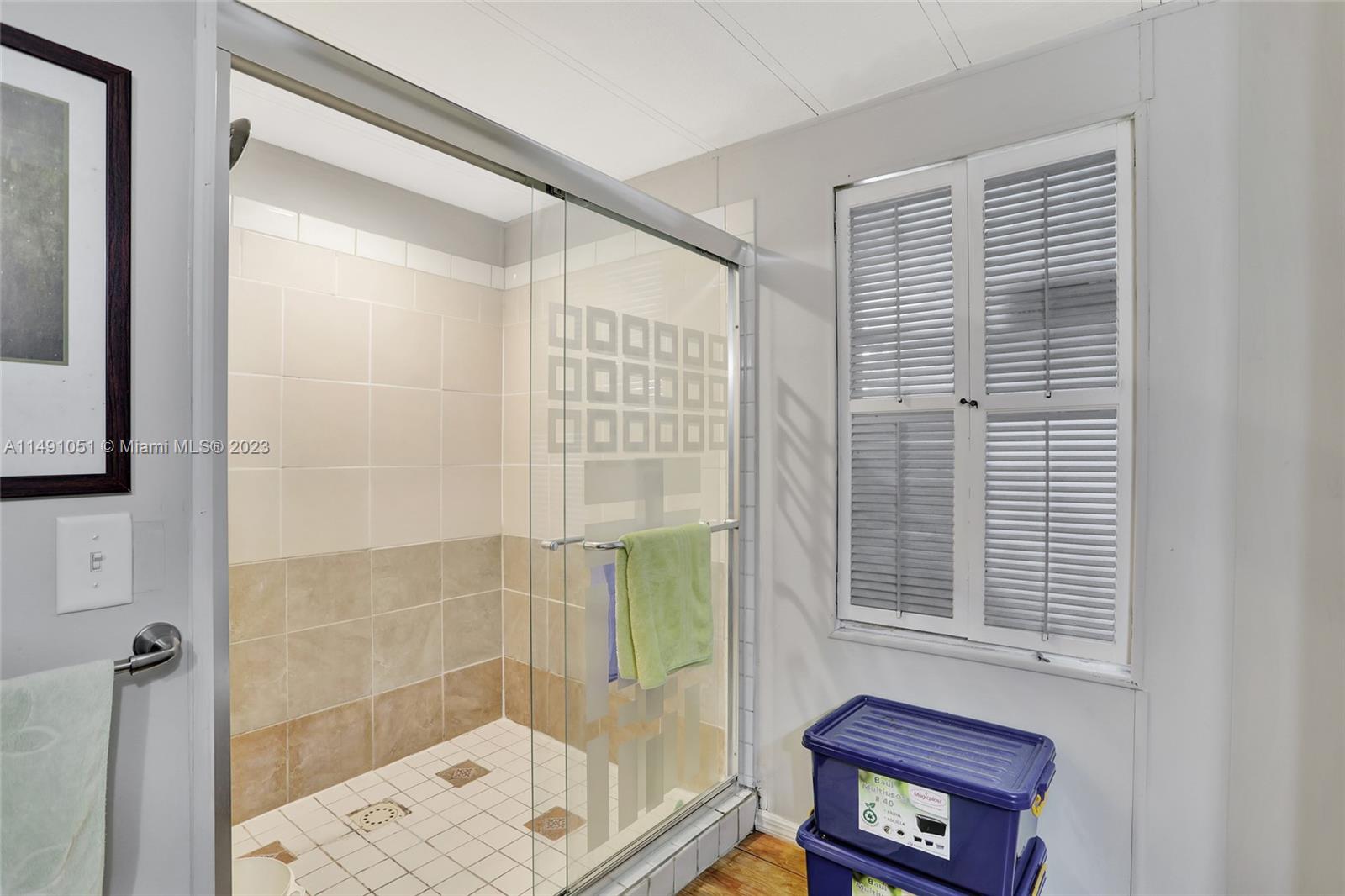 1640 Southwest 66th Avenue Boca Raton, FL 33428 - Photo 27 of 36 a bathroom with a shower and a window