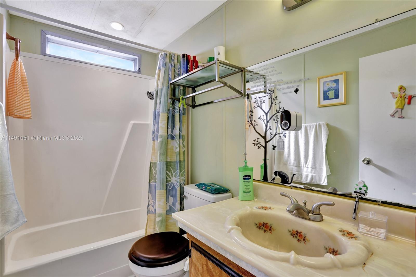 1640 Southwest 66th Avenue Boca Raton, FL 33428 - Photo 35 of 36 a bathroom with a tub sink and a mirror
