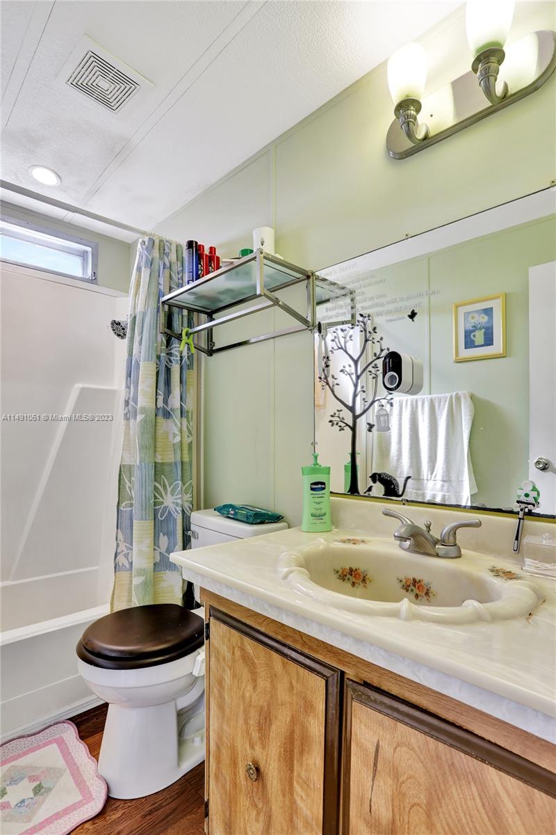 1640 Southwest 66th Avenue Boca Raton, FL 33428 - Photo 36 of 36 a bathroom with a sink and a mirror