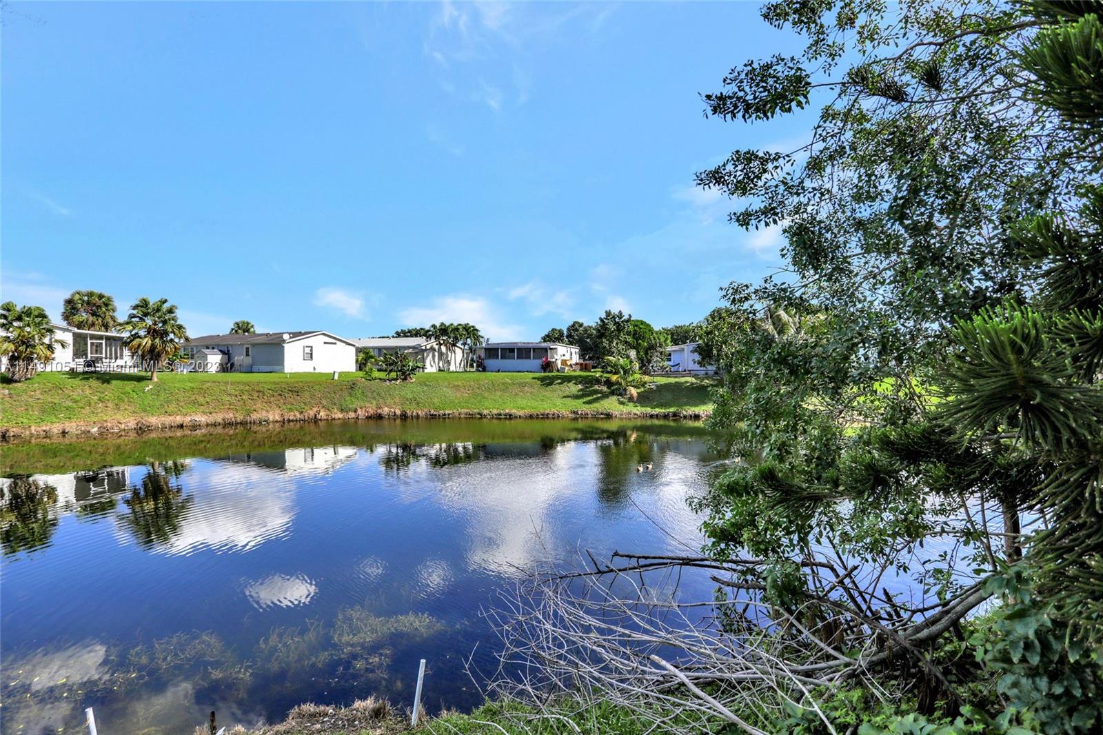 1640 Southwest 66th Avenue Boca Raton, FL 33428 - Photo 6 of 36 an aerial view of a house with a yard and lake view