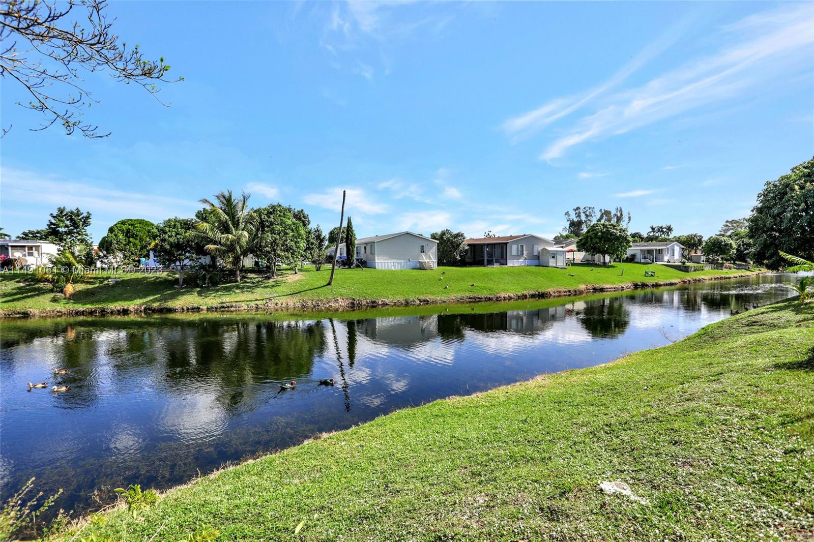 1640 Southwest 66th Avenue Boca Raton, FL 33428 - Photo 8 of 36 a view of a lake with a house in the background