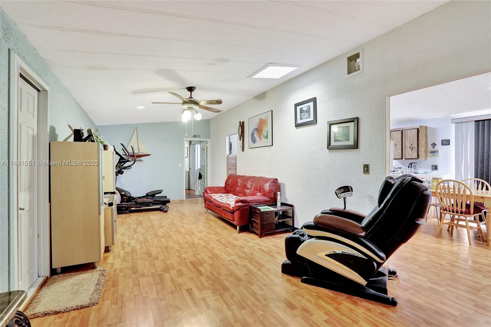 1640 Southwest 66th Avenue Boca Raton, FL 33428 - Photo 9 of 36 a living room with furniture gym equipment and a wooden floor