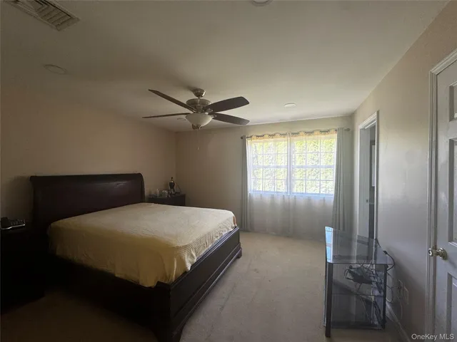 a bedroom with a bed and window