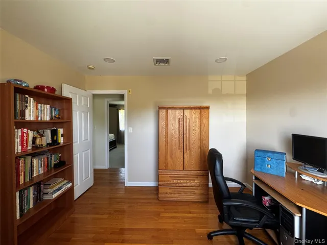 a view of a workspace with furniture and wooden floor