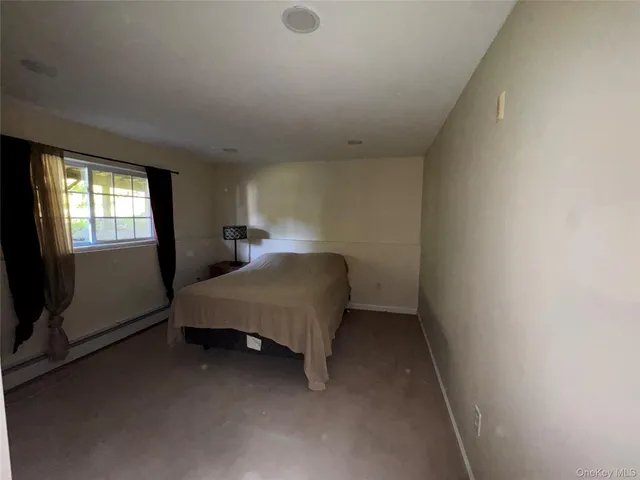 a room with a bed and window