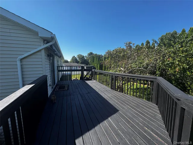 a view of balcony with wooden floor and fence
