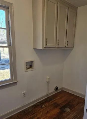 a view of a room with wooden floor and window