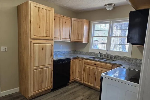 a kitchen with stainless steel appliances granite countertop a refrigerator sink and cabinets