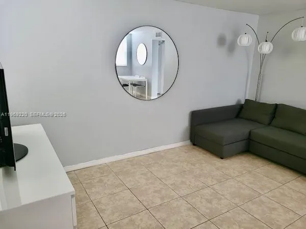 a white toilet sitting next to a white sink and vanity