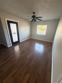 wooden floor in an empty room with a window