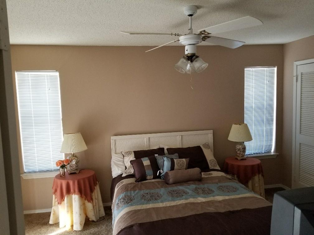 60 Sandprints Drive, Unit A2 Miramar Beach, FL 32550 - Photo 11 of 23 a bedroom with a bed and a chandelier