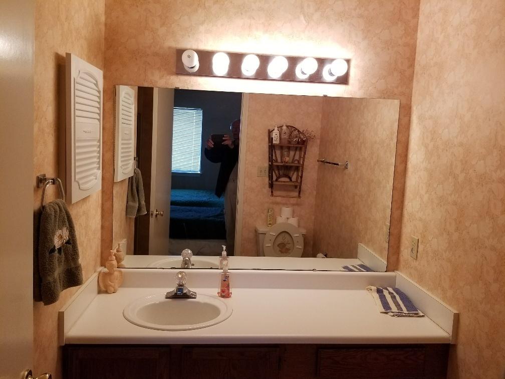 60 Sandprints Drive, Unit A2 Miramar Beach, FL 32550 - Photo 16 of 23 a bathroom with a sink and a mirror