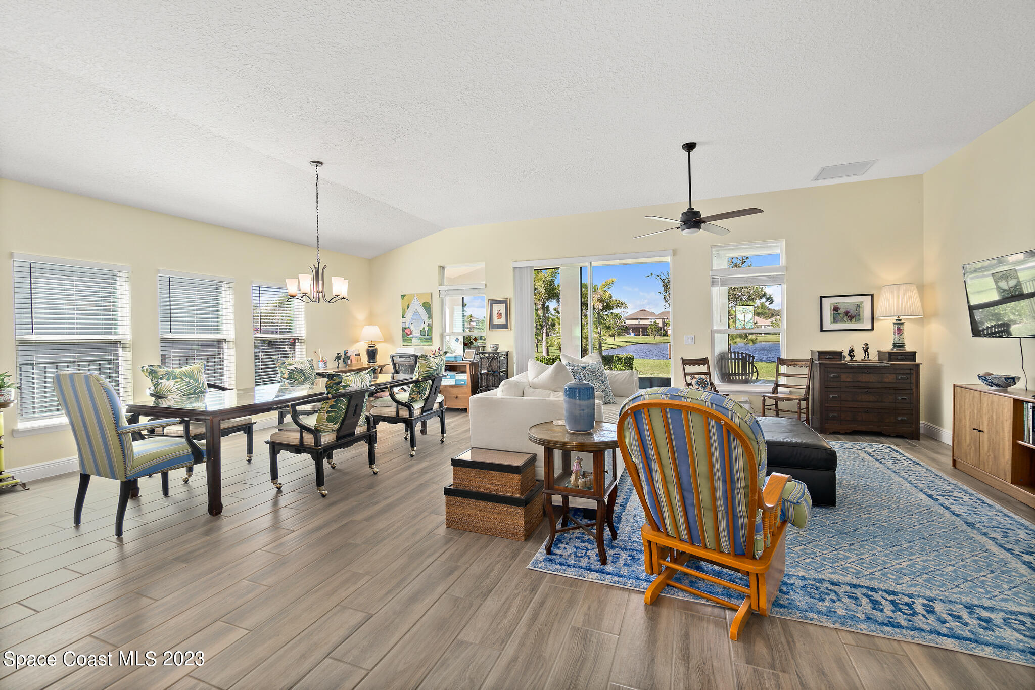 4465 Ruthann Circle Melbourne, FL 32934 - Photo 16 of 42 a living room with furniture a wooden floor and a dining table