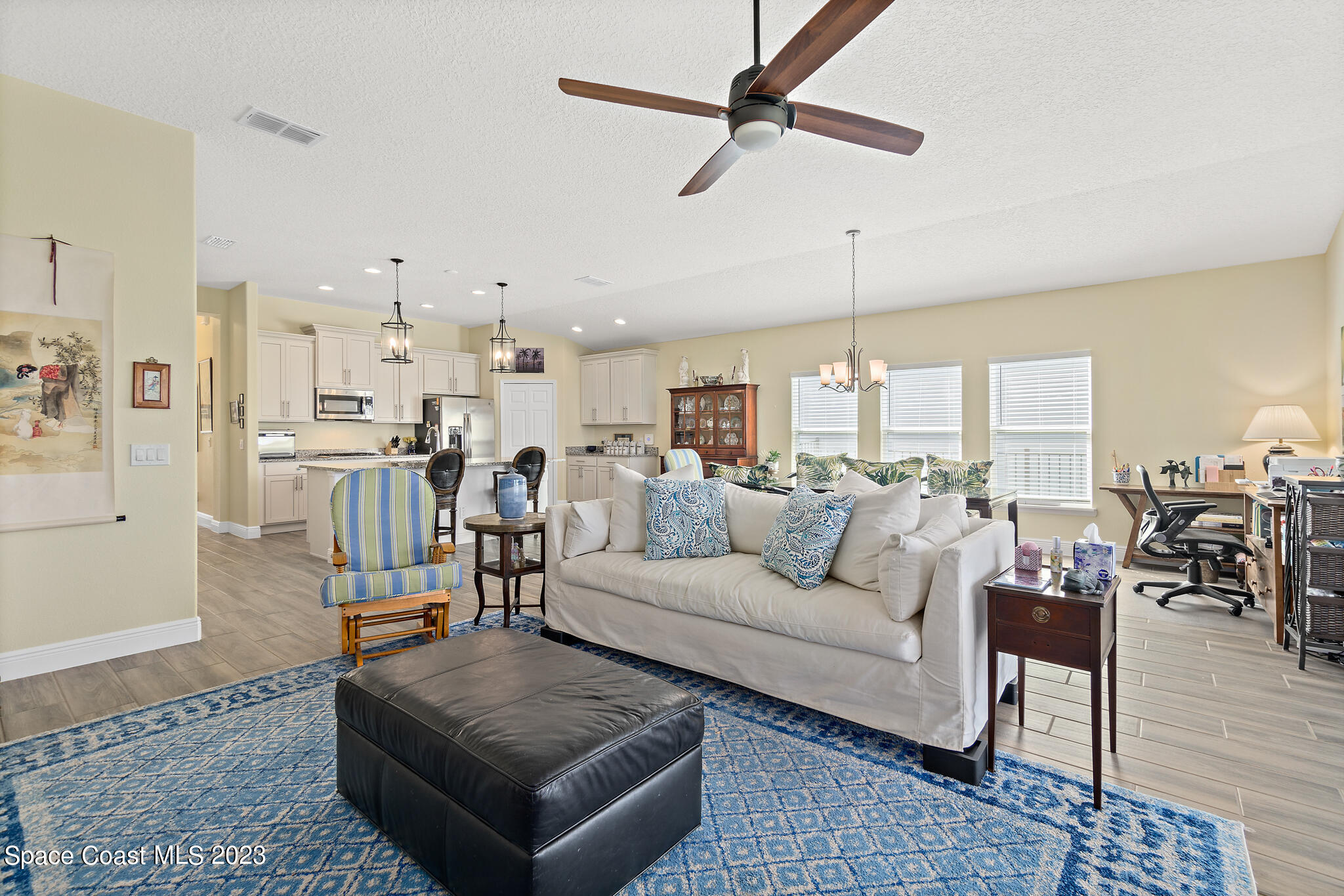 4465 Ruthann Circle Melbourne, FL 32934 - Photo 18 of 42 a living room with furniture and a view of kitchen