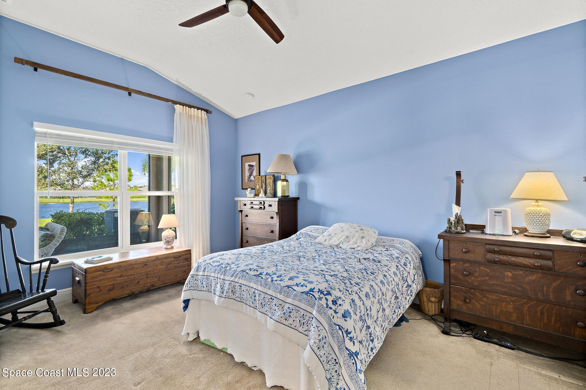 4465 Ruthann Circle Melbourne, FL 32934 - Photo 20 of 42 a bedroom with a bed a large window and couch