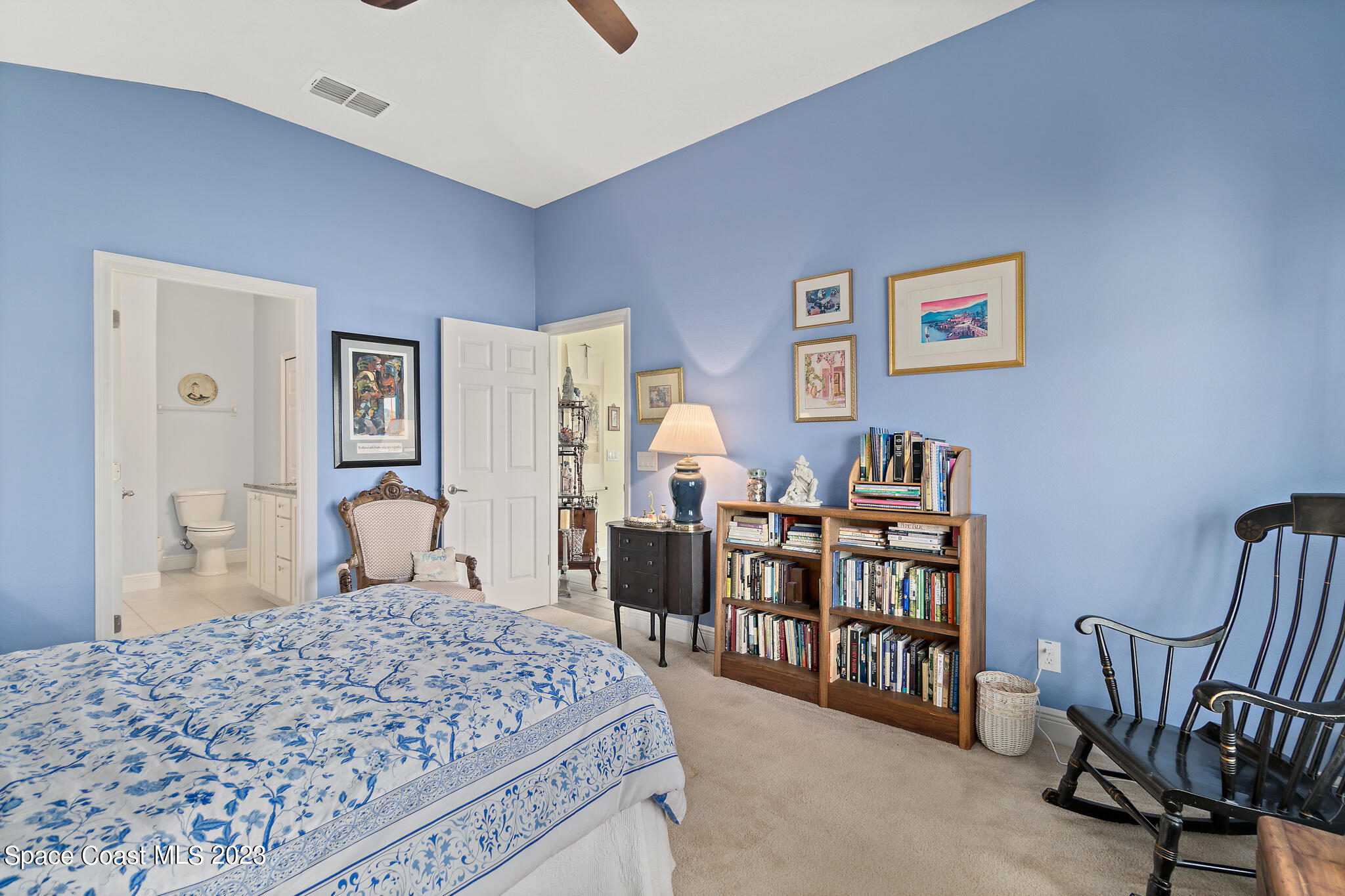 4465 Ruthann Circle Melbourne, FL 32934 - Photo 21 of 42 a bedroom with a bed a rug and chair