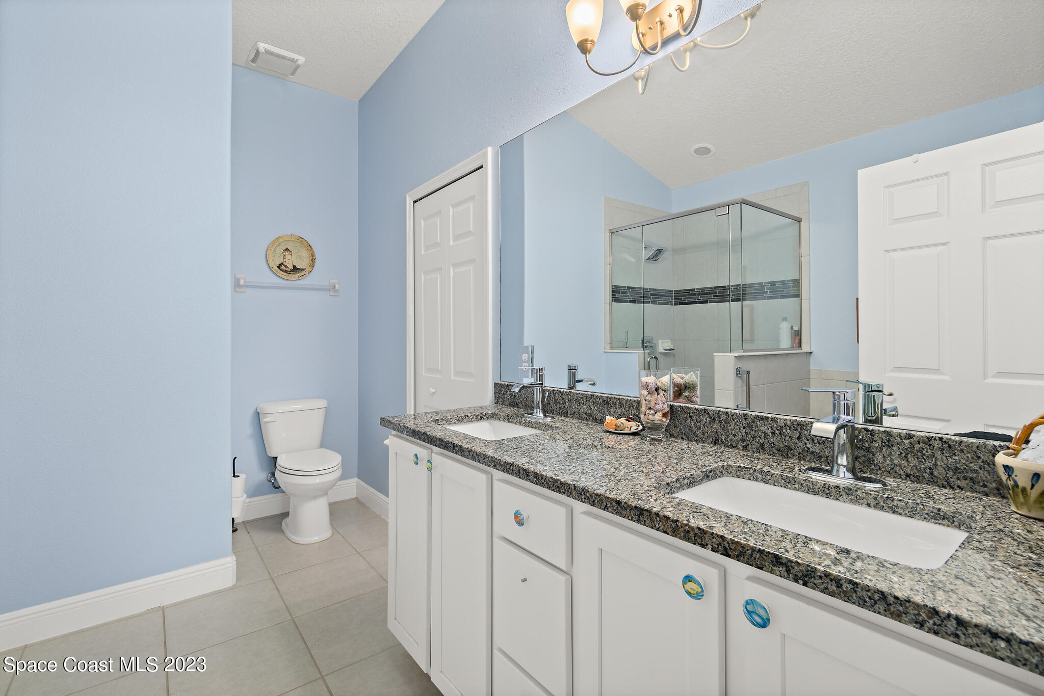 4465 Ruthann Circle Melbourne, FL 32934 - Photo 22 of 42 a bathroom with a granite countertop sink and a mirror