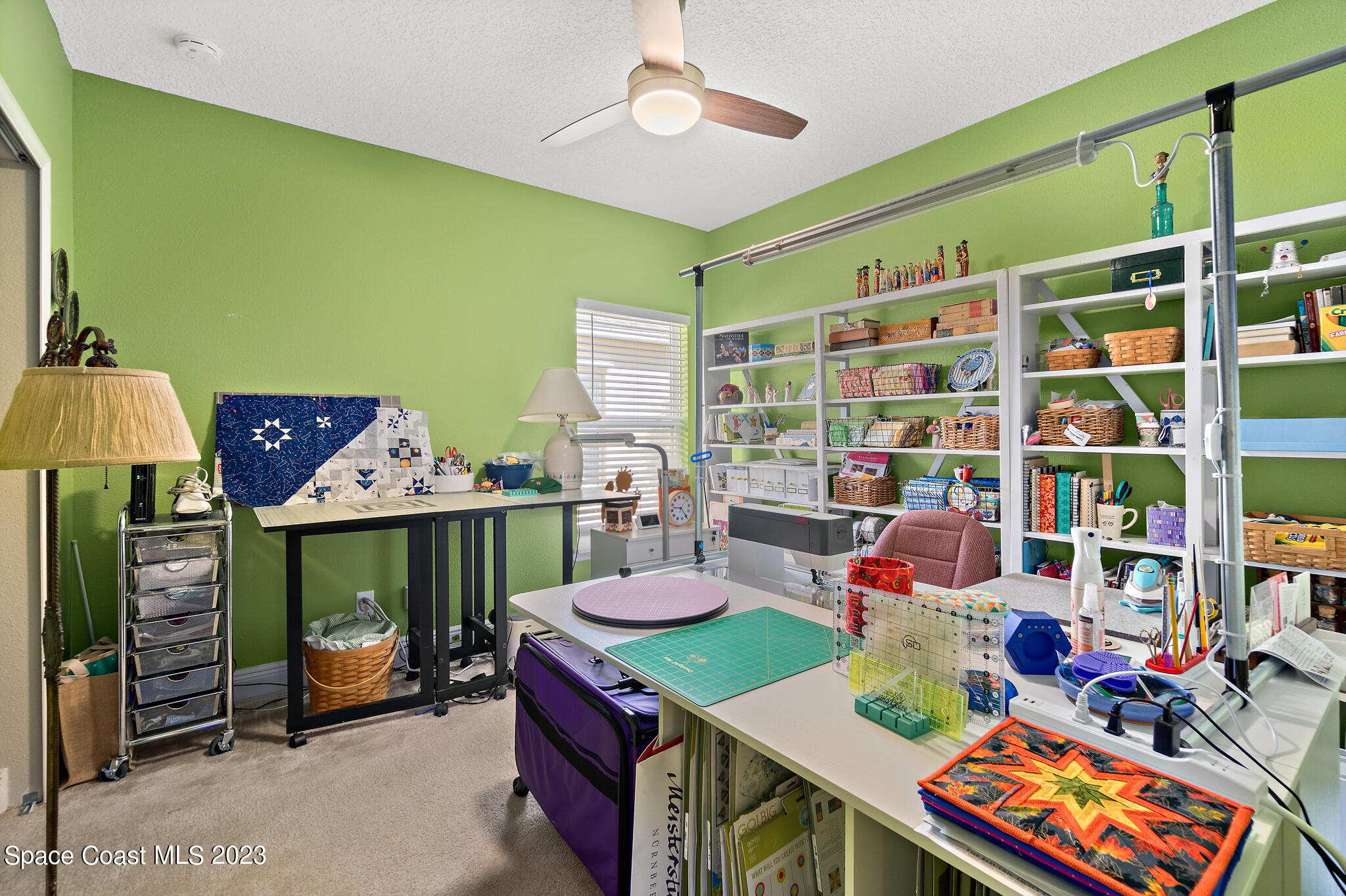4465 Ruthann Circle Melbourne, FL 32934 - Photo 28 of 42 a work room with furniture and a chandelier
