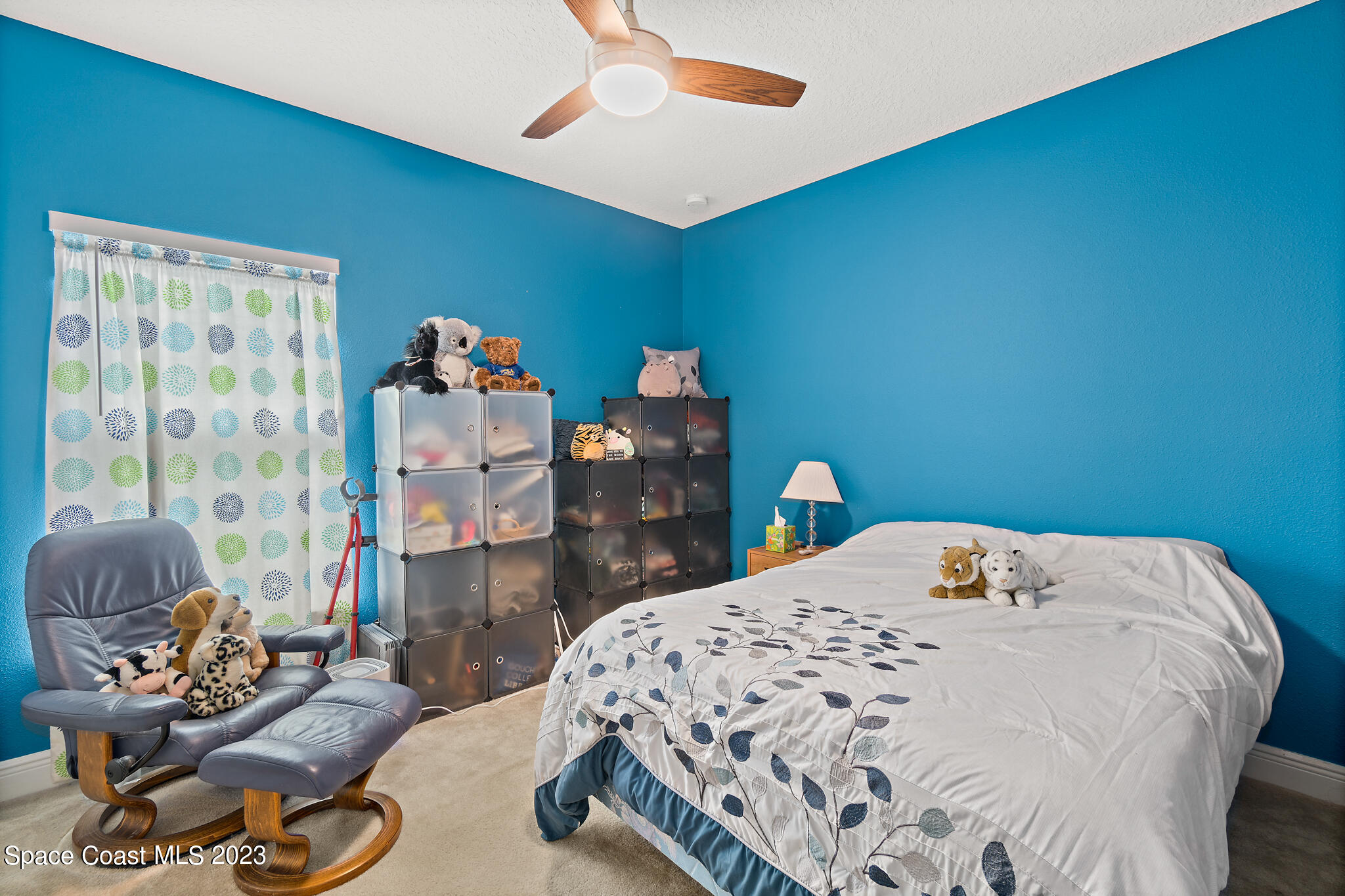 4465 Ruthann Circle Melbourne, FL 32934 - Photo 29 of 42 a bedroom with a bed dresser and a window