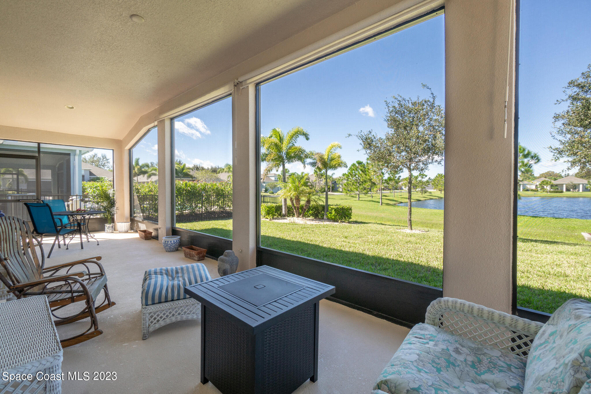 4465 Ruthann Circle Melbourne, FL 32934 - Photo 31 of 42 a living room with furniture and a floor to ceiling window