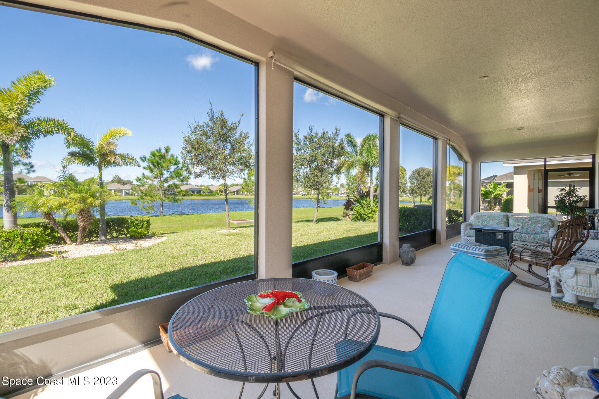 4465 Ruthann Circle Melbourne, FL 32934 - Photo 33 of 42 a living room with furniture and a floor to ceiling window